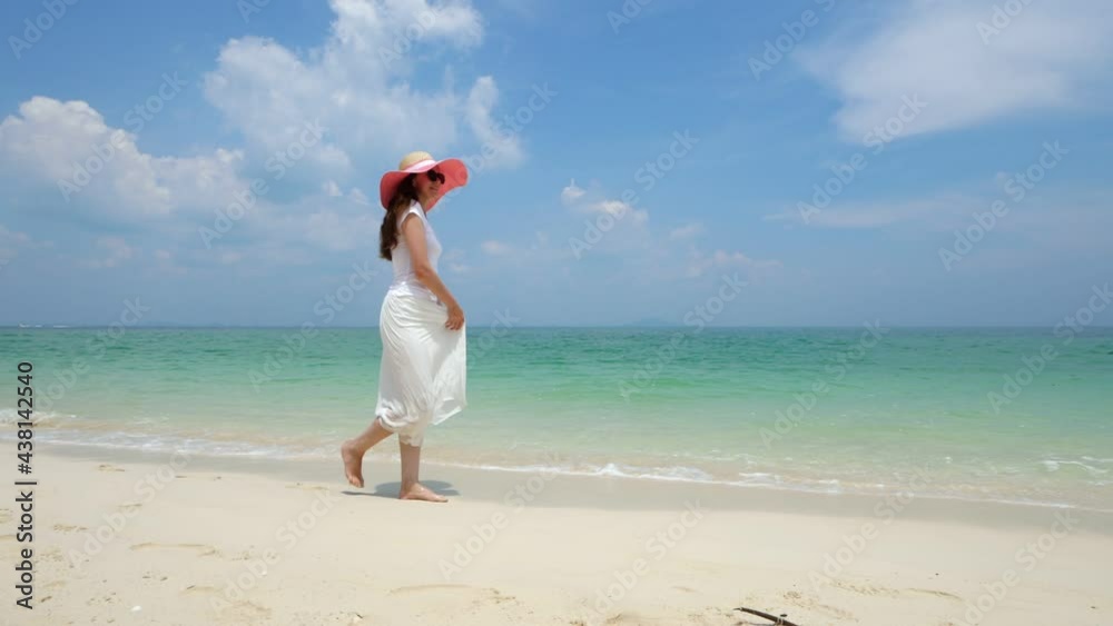 Just walk along beach without reflecting on anything, happy woman on holidays at tropical island. She enjoy beautiful nature and hot weather, stroll at sea shore, slow motion shot Just walk along beach without reflecting on anything, happy woman on holidays at tropical island. She enjoy beautiful nature and hot weather, stroll at sea shore, slow motion shot