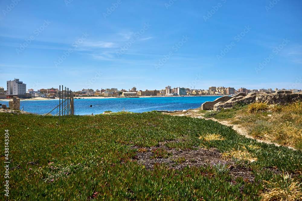 the ruins of the ancient Tonnata Tipa and in the background the sea and the city of Trapani