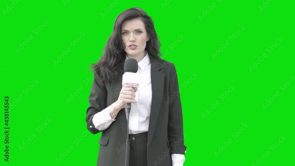 GREEN SCREEN CHROMA KEY Mid 30s Caucasian female TV news reporter in formal wear talking against green background. Shot outside on windy overcast day GREEN SCREEN CHROMA KEY Mid 30s Caucasian female TV news reporter in formal wear talking against green background. Shot outside on windy overcast day