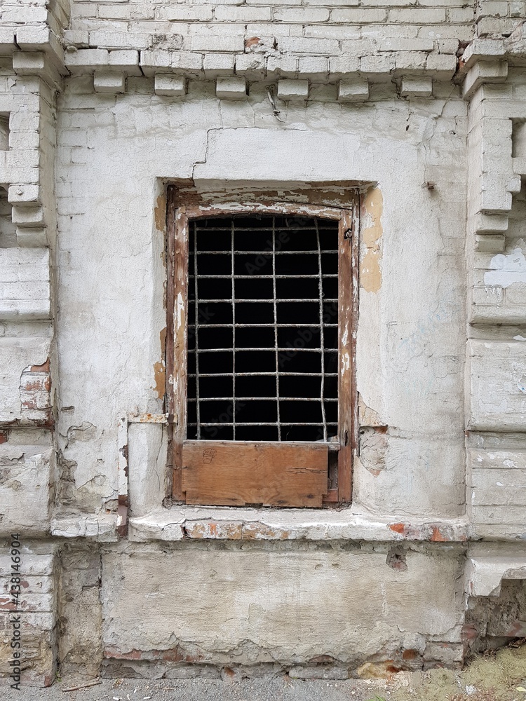 An old barred window in an abandoned house