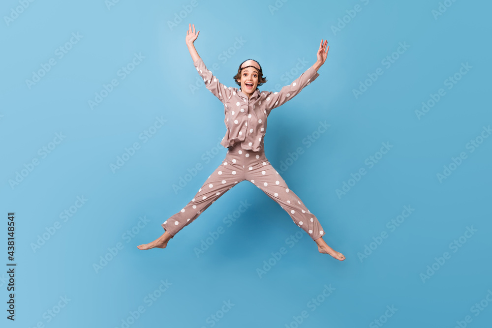 Full size photo of optimistic short hairdo lady jump wear beige pajama mask isolated on blue color background