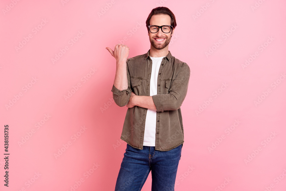 Photo of young handsome man happy positive smile point thumb empty space ad suggest isolated over pastel color background Photo of young handsome man happy positive smile point thumb empty space ad suggest isolated over pastel color background