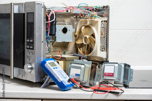 New and old magnetrons, and the tester next to the disassembled microwave photo