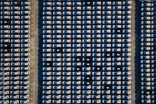 Aerial view a lot of new car lined up in the port for import and export business logistic to dealership.