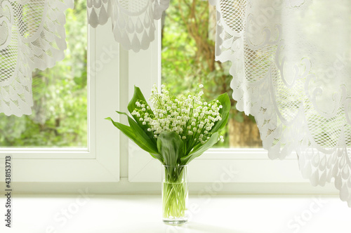 Bouquet of lily of the valley on the windowsill