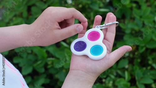 New popular silicone popit toy, baby is playing with it. Rainbow Trendy Pop it fidget toy