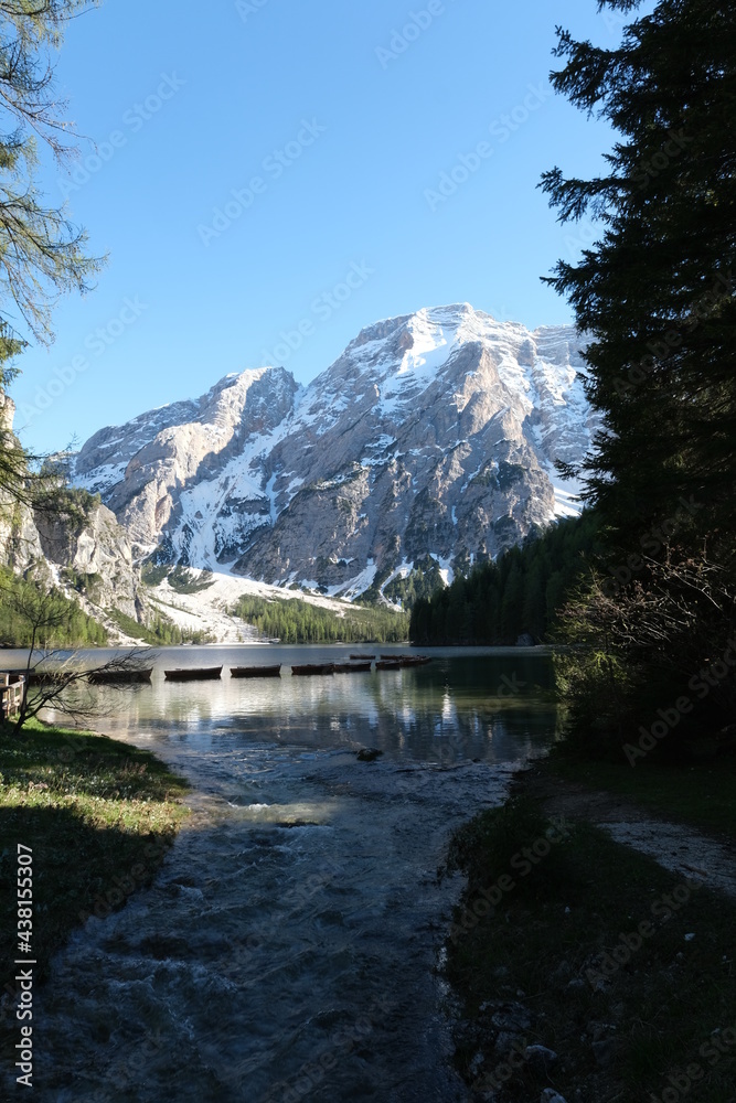 The fabulous alpine lake of Braies in the Dolomites (Bolzano). Lovely place in the Italian Alps. Boats on the water. Reflections in the water. Sunny spring day. Trentino Alto Adige