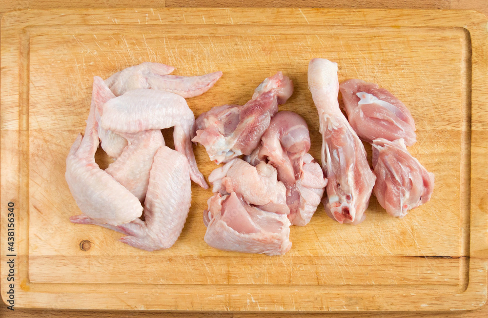 Chicken cut into pieces on a cutting board