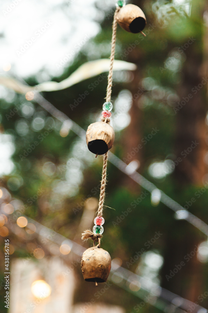 Decor with bronze bells on a natural location in the forest Decor with bronze bells on a natural location in the forest