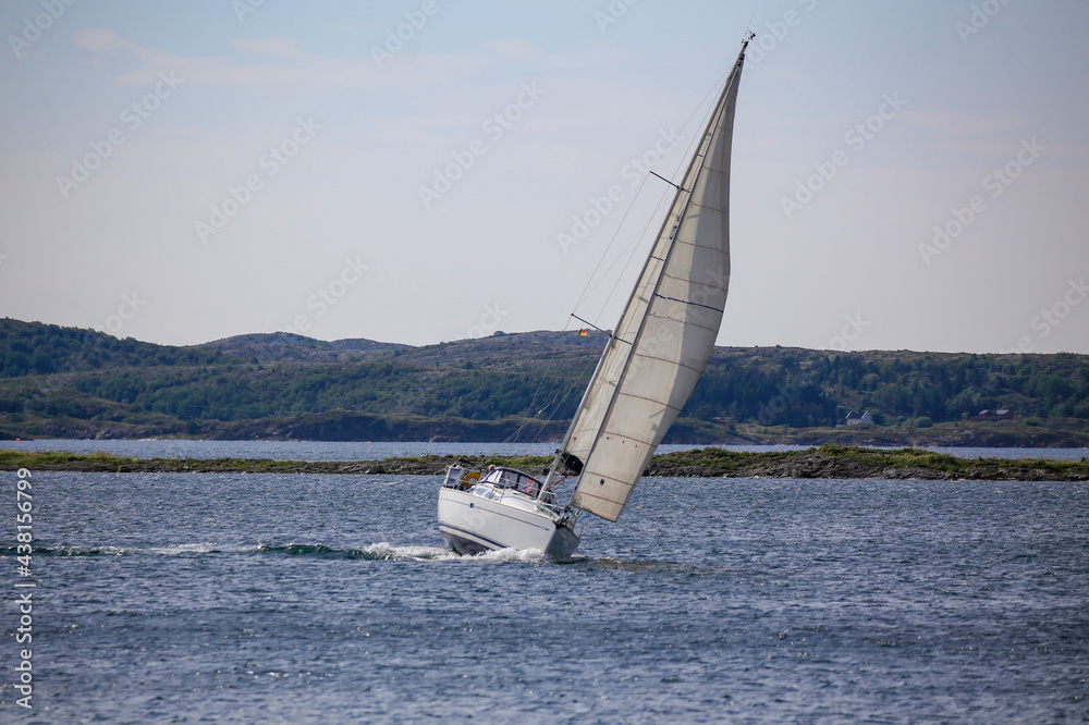Obraz premium Sailboat with wind in the sails along the Norwegian coast,Helgeland,Nordland county,Norway,scandinavia,Europe