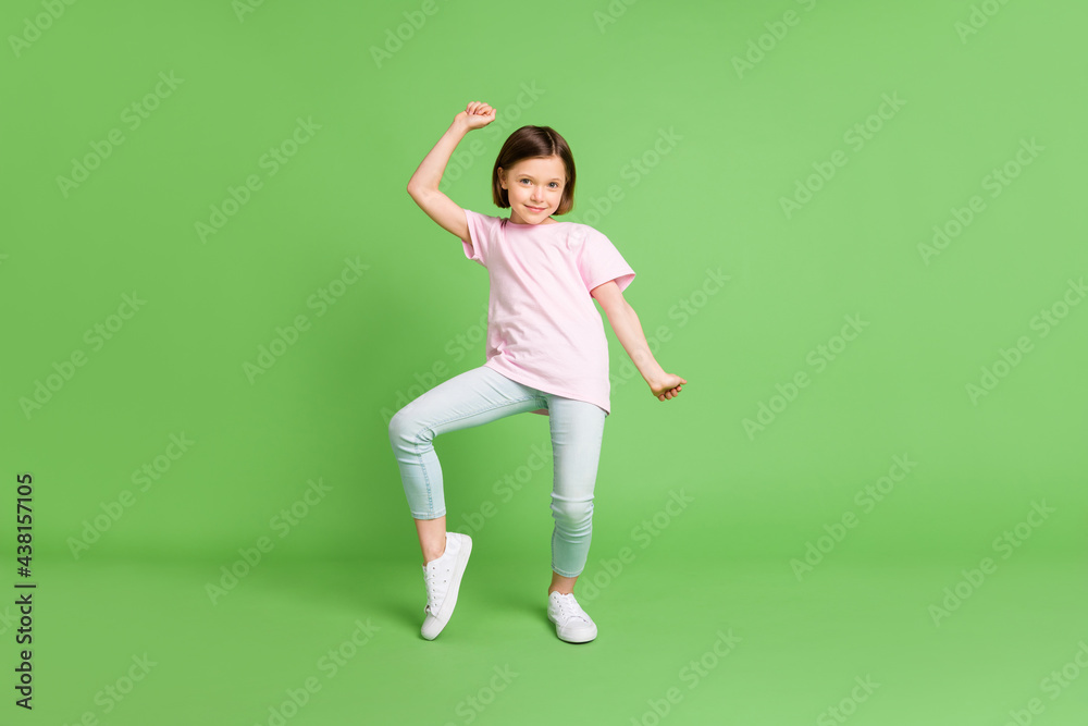 Full size photo of young lovely girl happy positive smile have fun dance isolated over green color background Full size photo of young lovely girl happy positive smile have fun dance isolated over green color background