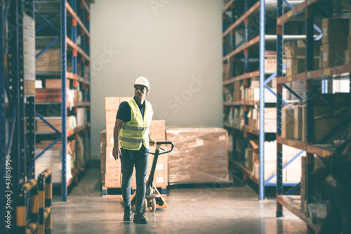 A man woker using forklift in warehouse, foreman wearing helmet and safety vest in storehouse, manager checking stock, warehouse full of shelves, Forklift Working in Logistics Storehouse