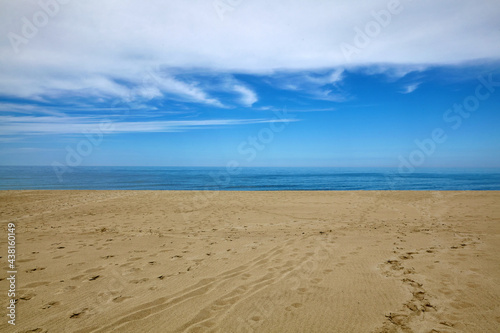 White clouds  blue sea and yellow sandy beach