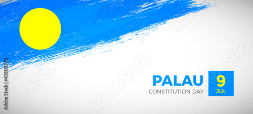 Happy constitution day of Palau with brush painted grunge flag background