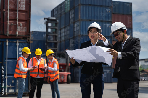 Fotografie The supervisor are checking the containers box from cargo ship for export and im