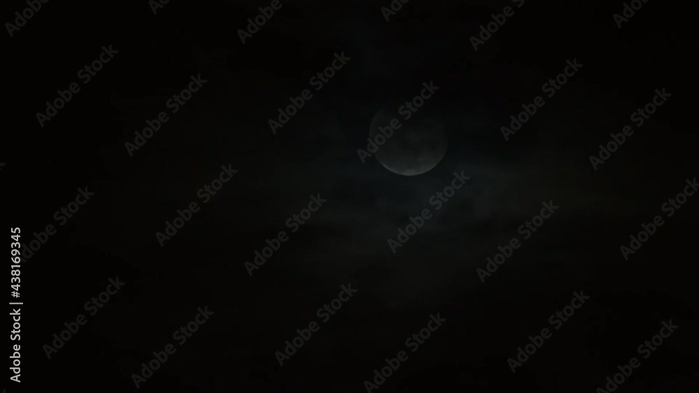 Clouds passing by moon at night. Full moon at night with cloud real time Clouds passing by moon at night. Full moon at night with cloud real time