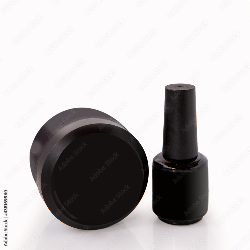 Cosmetics for hand care. Nail plate coating in black doses on a white background Cosmetics for hand care. Nail plate coating in black doses on a white background