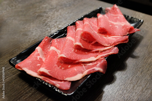 Thin beef slices on a plate.