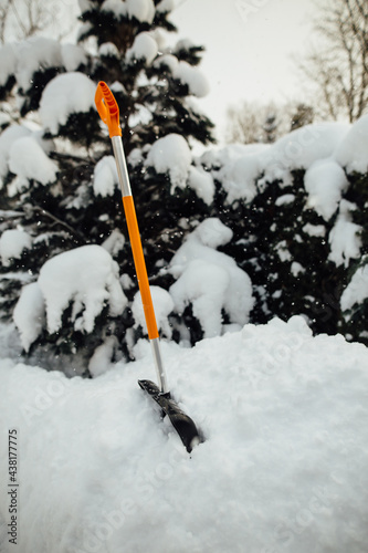 Snow shovel in the snow.
snow removal tools