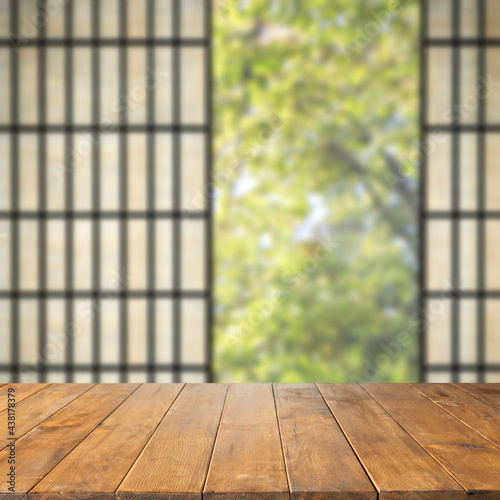 Wooden desk of free space and window background 