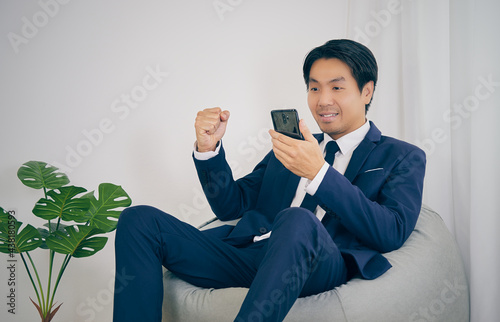 Asian Financial Advisor Happy and Success with Customer Dealing in Home Office. Businessman Work at Home for Social Distance or Home Quarantine in Covid 19 Coronavirus Situation in Vintage Tone