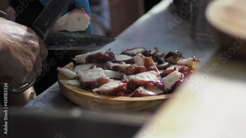 Skillful hands cutting Galician octopus fair style 2 photo