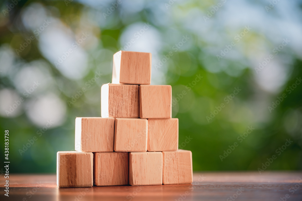 Wood block stacking as step stair to show concepts to strategy business growth to success with natural green background. Wood block stacking as step stair to show concepts to strategy business growth to success with natural green background.