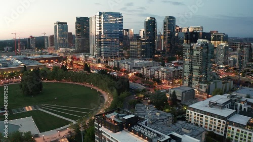 Cinematic 4K drone rise and reveal night footage of the city center of Bellevue, Downtown Park, Bellevue Square, illuminated skyscrapers, office and apartment buildings during blue hour after sunset photo