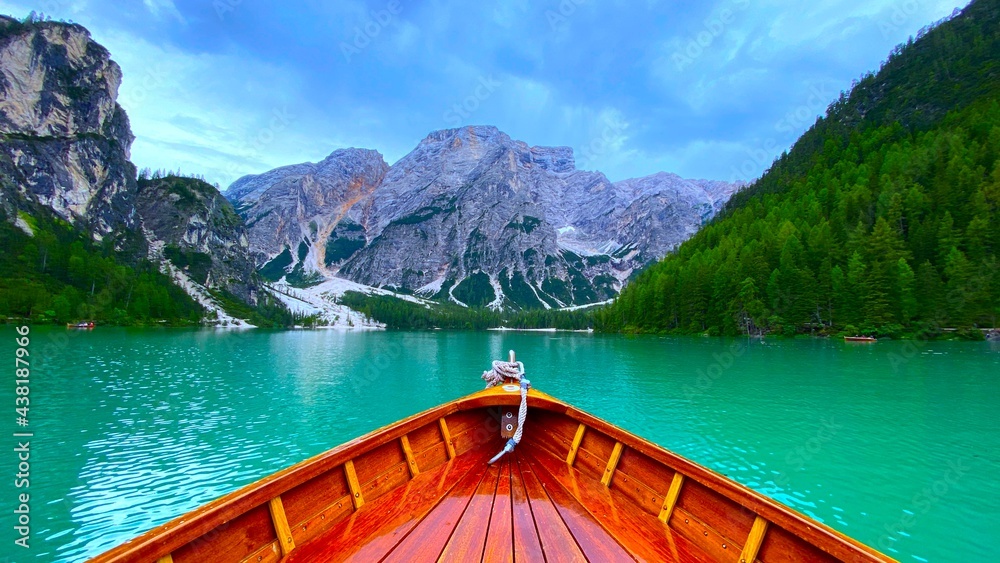 Wooden boat in Lake of braise with mountain and cloudy sky