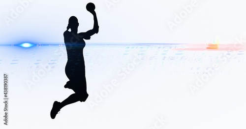 Composition of female handball player on white background with light trails
