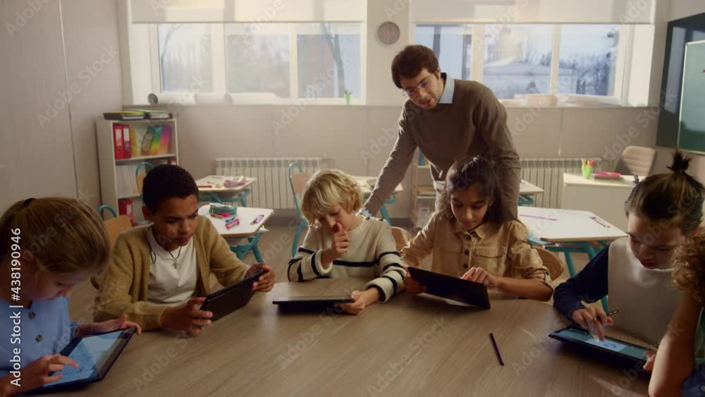 Students doing class work on digital tablets. Pupils using tablet computers