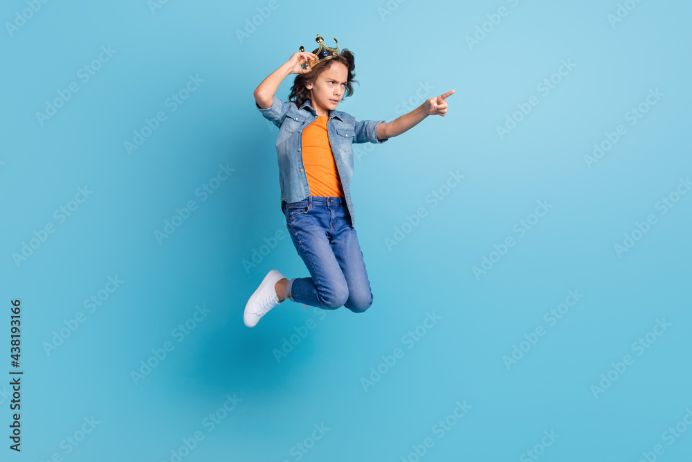 Full length profile side photo of young boy kid jump unhappy angry point finger empty space isolated over blue color background