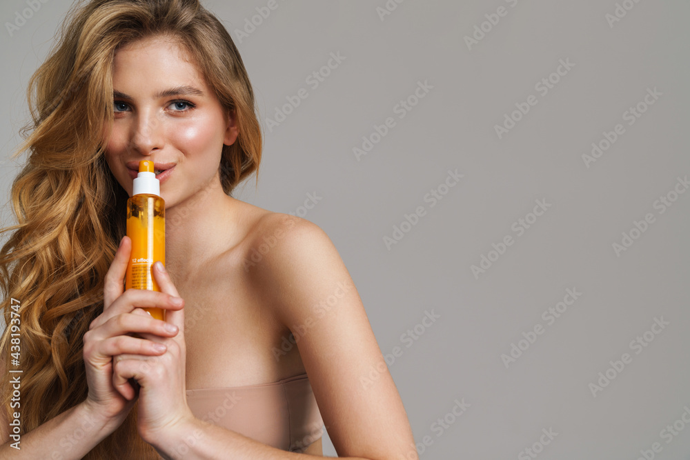 Half-naked white ginger woman posing with beauty product Half-naked white ginger woman posing with beauty product