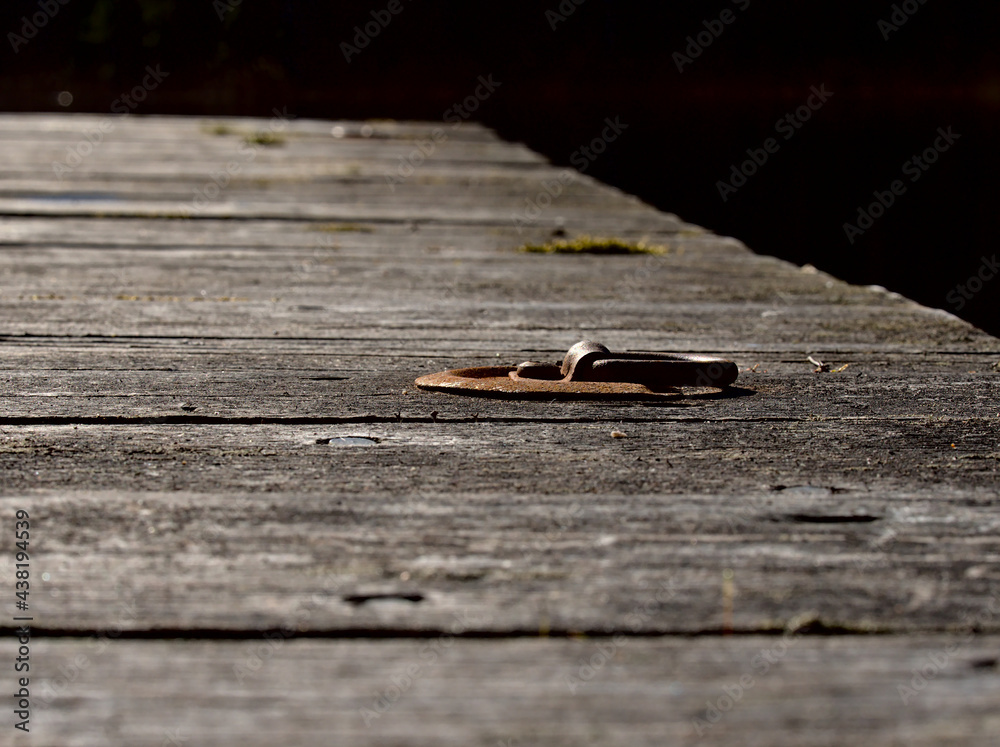 A lonely mounting ring of an old wooden pier A lonely mounting ring of an old wooden pier