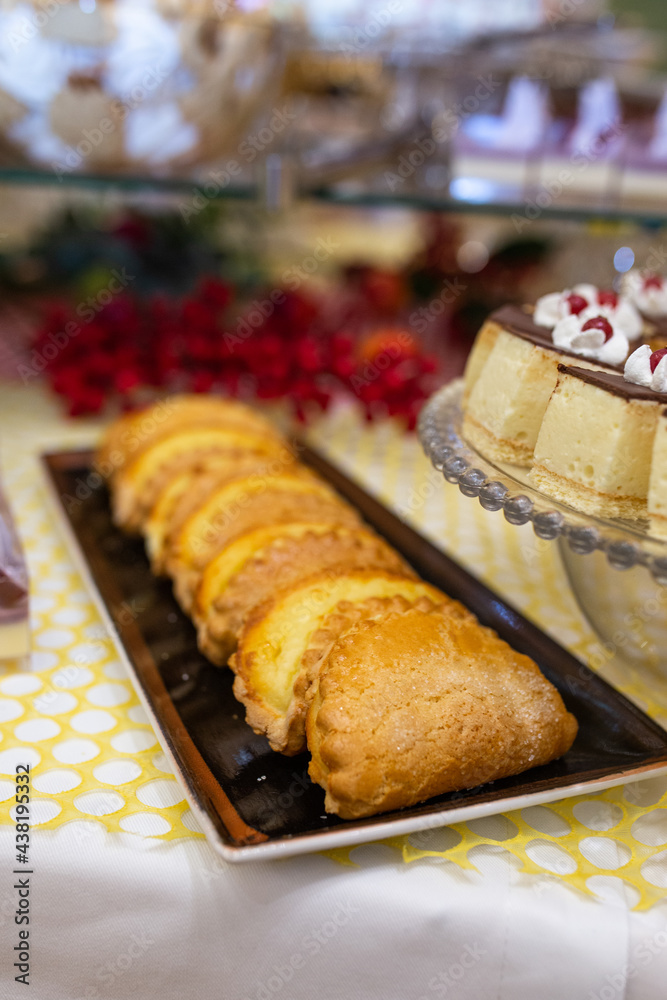 sweet shortbread cookies on a black plate on the table with sweets