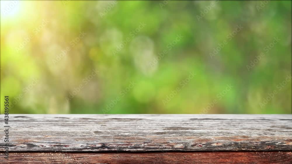 Empty wooden table with fresh green bokeh background Empty wooden table with fresh green bokeh background
