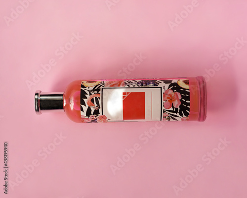 pink perfume bottle on pink background
