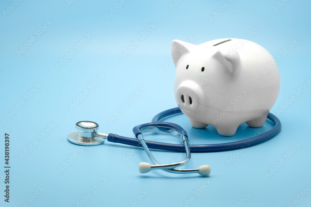 Piggy bank with stethoscope isolated on light blue background with copy space. Health care financial checkup or saving for medical insurance costs concept. - obrazy, fototapety, plakaty 