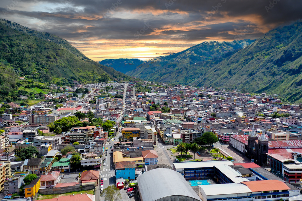 Fototapeta premium Aerial view over banos, a small city in the andes mountains in Ecuador during sunset