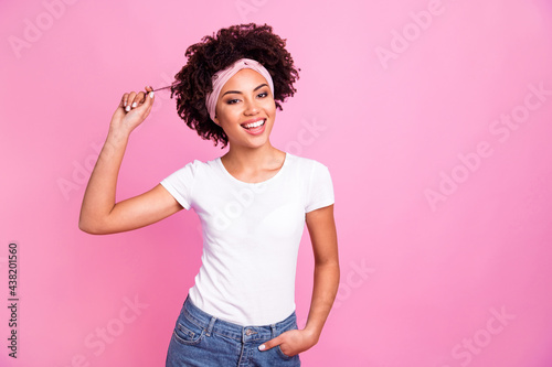 Photo of brunette touch hair wear white t-shirt hairband isolated on pastel pink background
