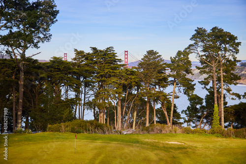 A golf course in San Francisco. In the background you can see the world famous Golden Gate Bridge. Day. Feel like playing golf? Let's go!