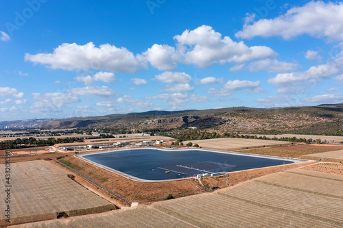 Floating Solar panels in a large water reservoir, Aerial view.

