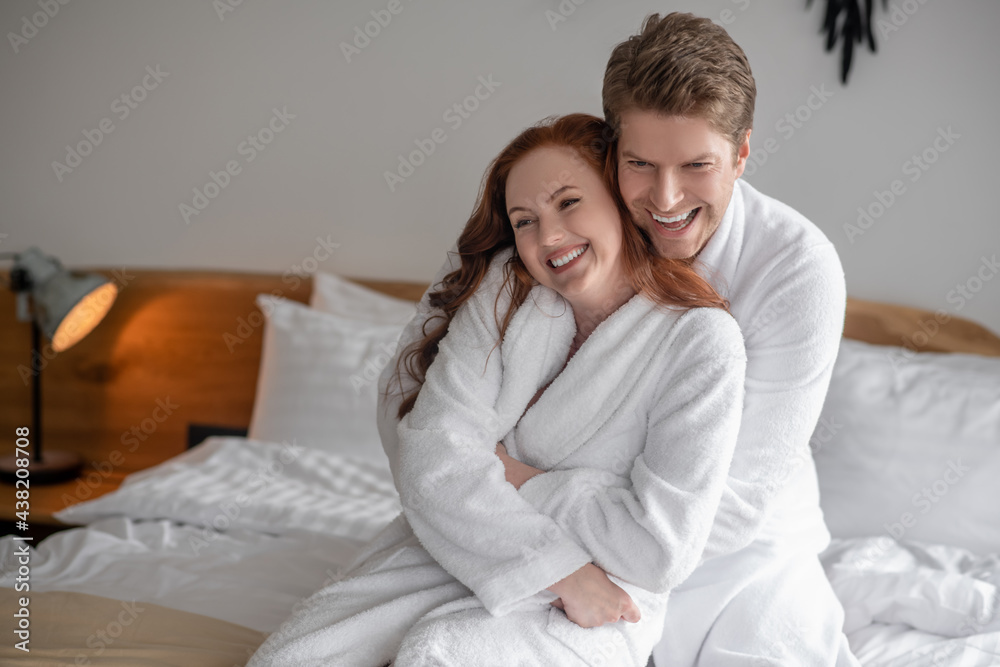 A cute couple spending time together at home and looking happy A cute couple spending time together at home and looking happy