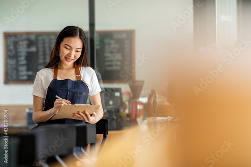 Portrait of Startup successful small business owner in coffee shop.woman barista cafe owner. SME entrepreneur seller business concept	