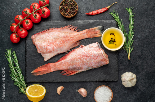 Raw red sea bass fish on stone background