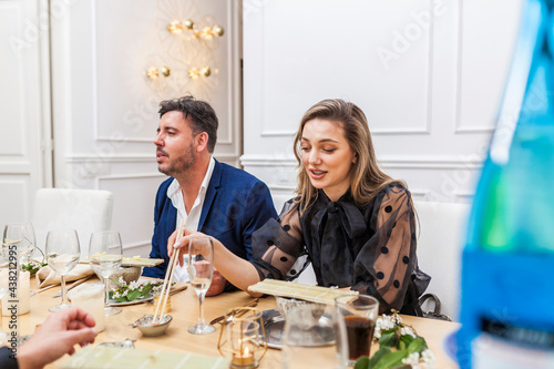 Friends eating and conversating at a dinner party photo