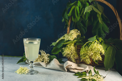 Photography Soft drink with ice cubes from elderflower syrup, juice or champagne in a glass