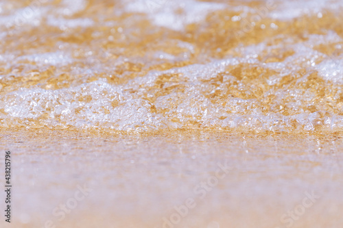 oncoming wave on the fine sea sand on the shore