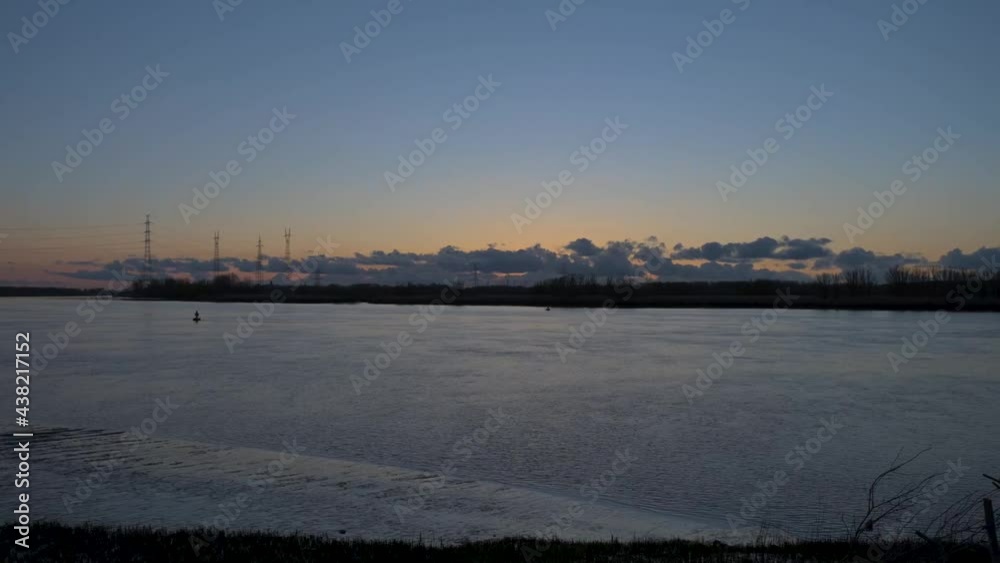 Panoramic static timelapse of Schelde river at dramatic cloudy dawn Panoramic static timelapse of Schelde river at dramatic cloudy dawn