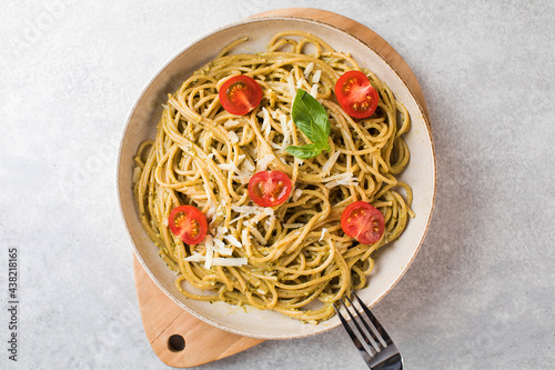 Spaghetti pasta with pesto sauce and cherry tomatoes. Top view
